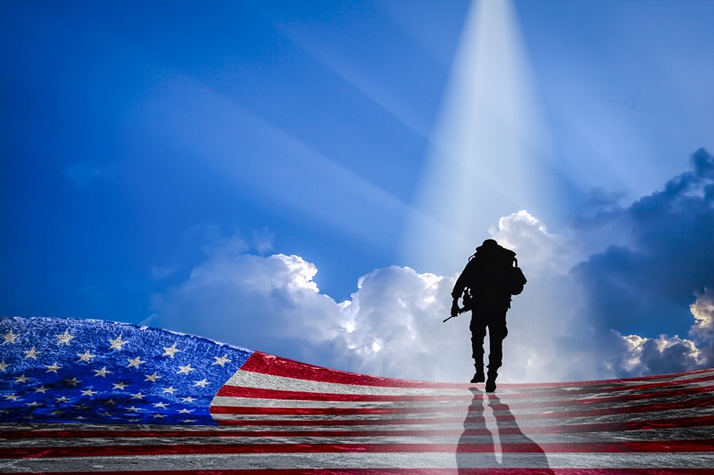 veteran with flag and clouds