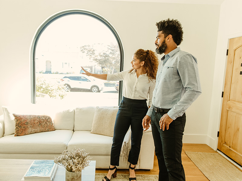 A family speaking with a real estate agent. 