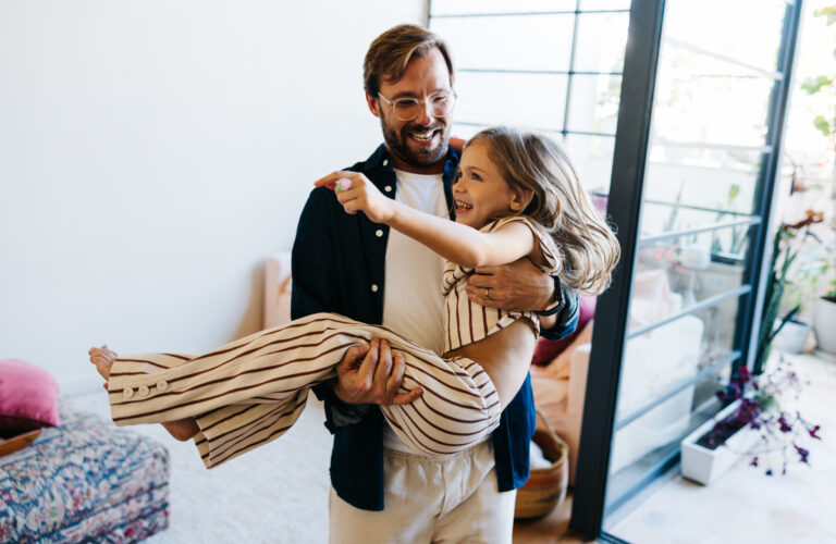 Dad and girl carries in new house