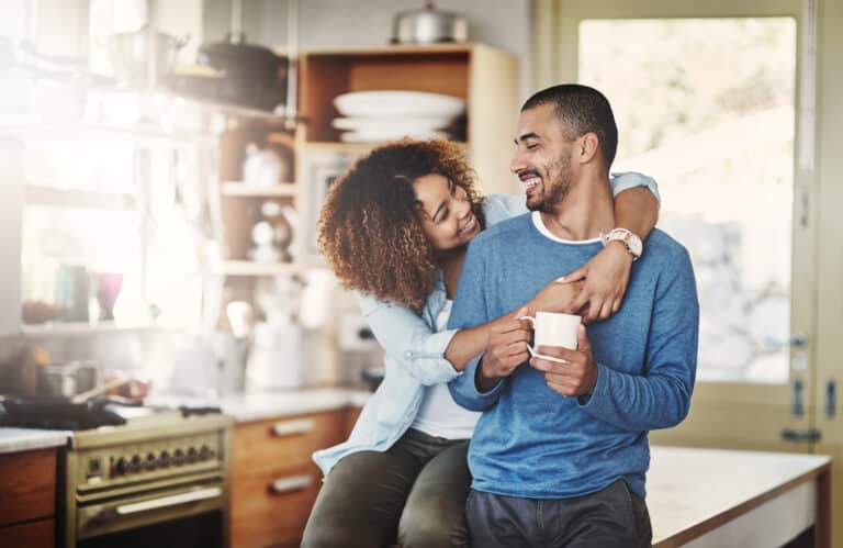 Couple embracing at home after securing a 30-year fixed-rate mortgage